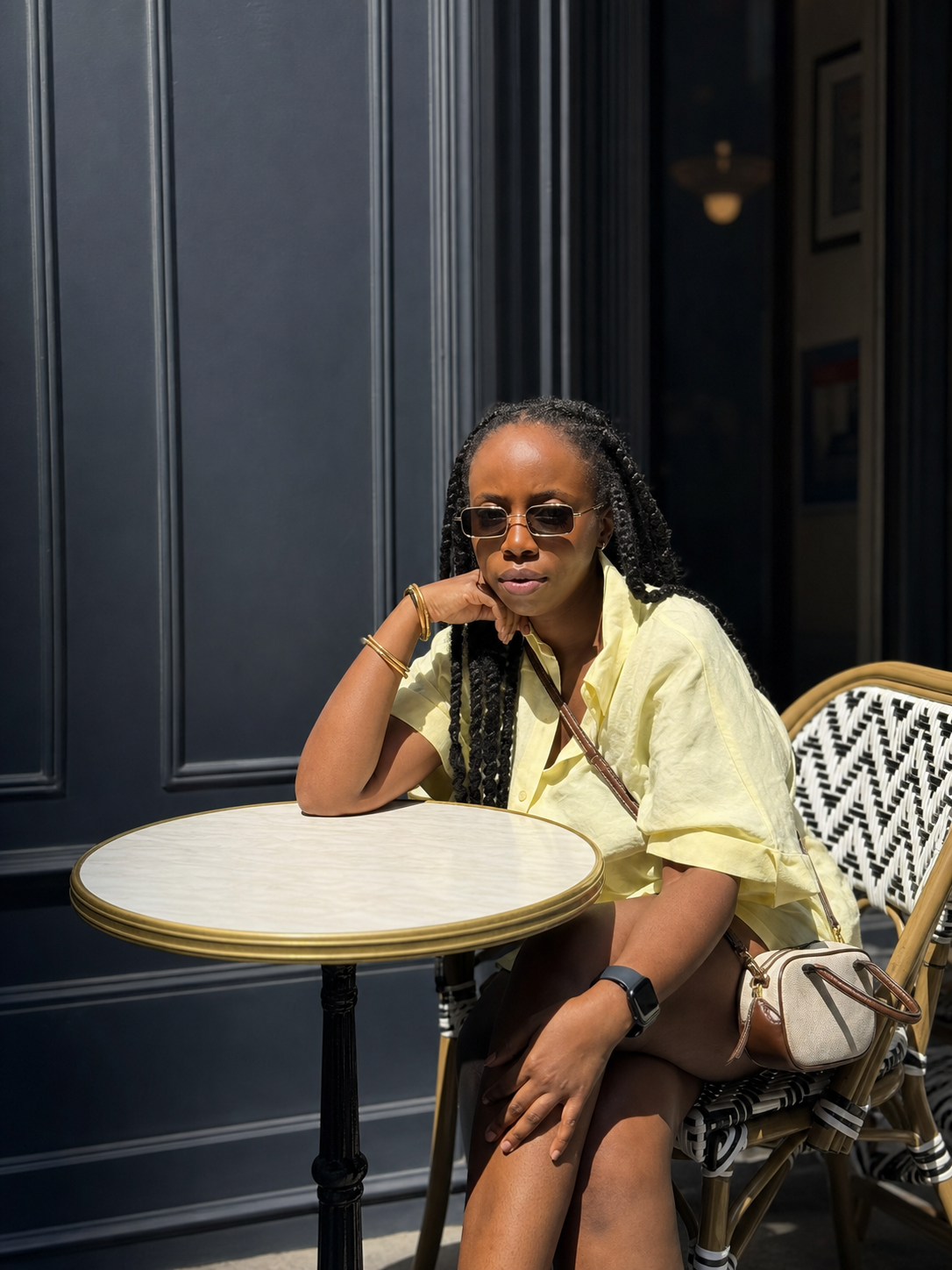 Nkem seated at a café